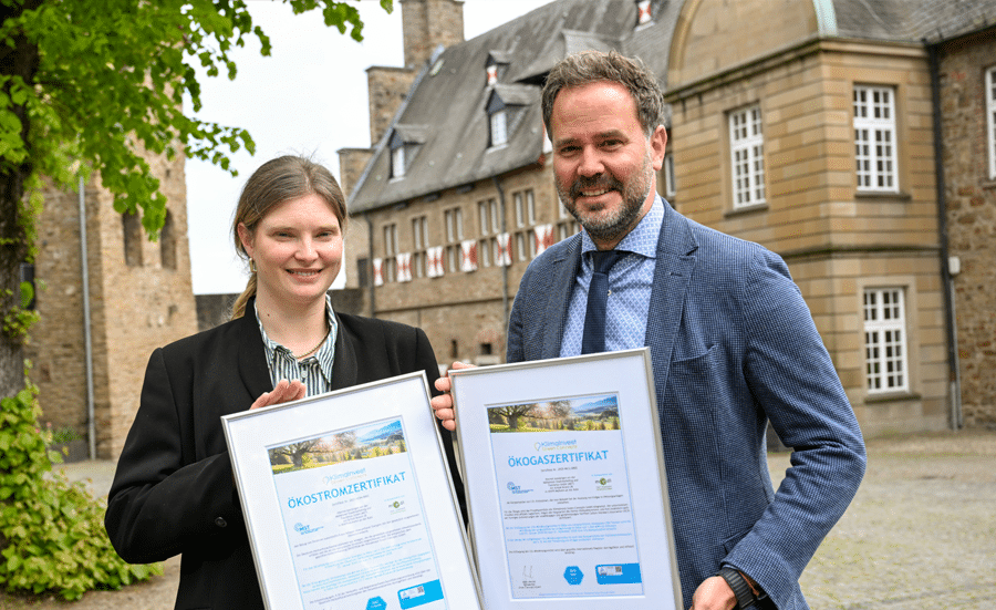 Jan Hoffmann und Johanna Pieper präsentieren die Nachhaltigkeitszertifikate am Schloss Broich.